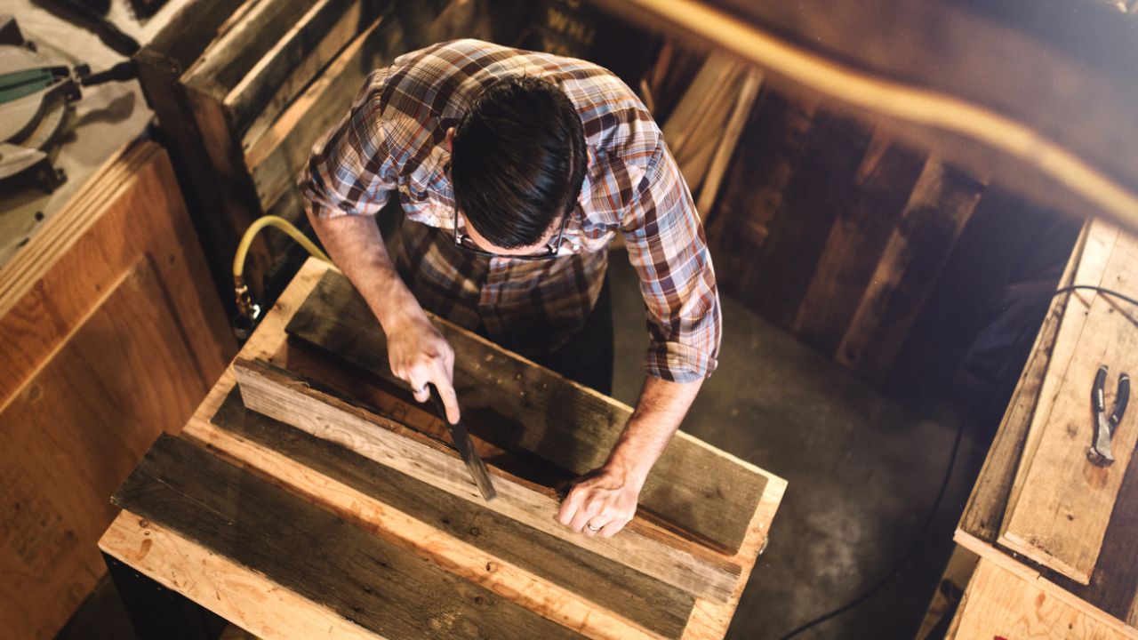 photo of man working with reclaimed wood