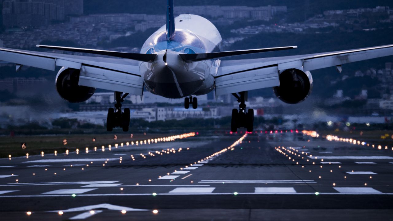 Close-up from rear of passenger jet landing at night.