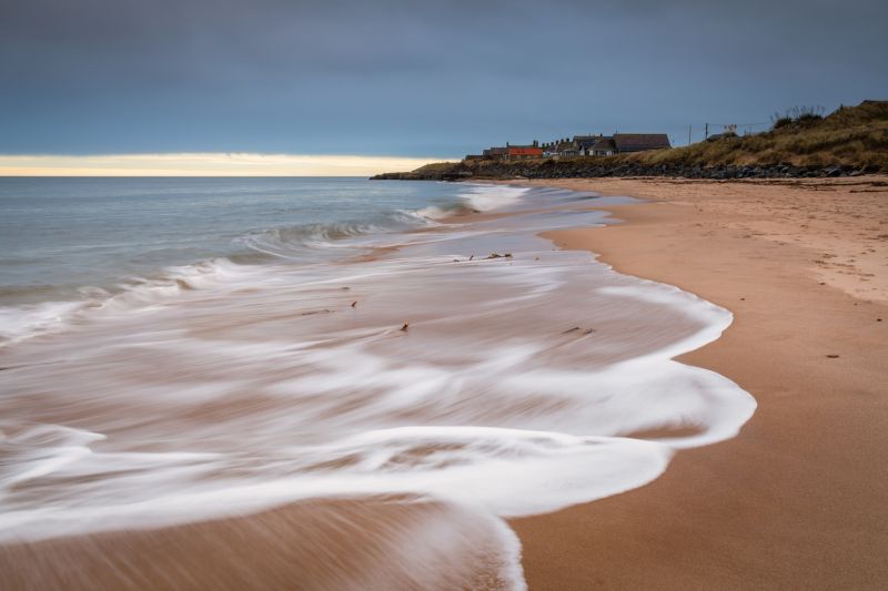 photo of Cresswell Village from the beach at Druridge Bay