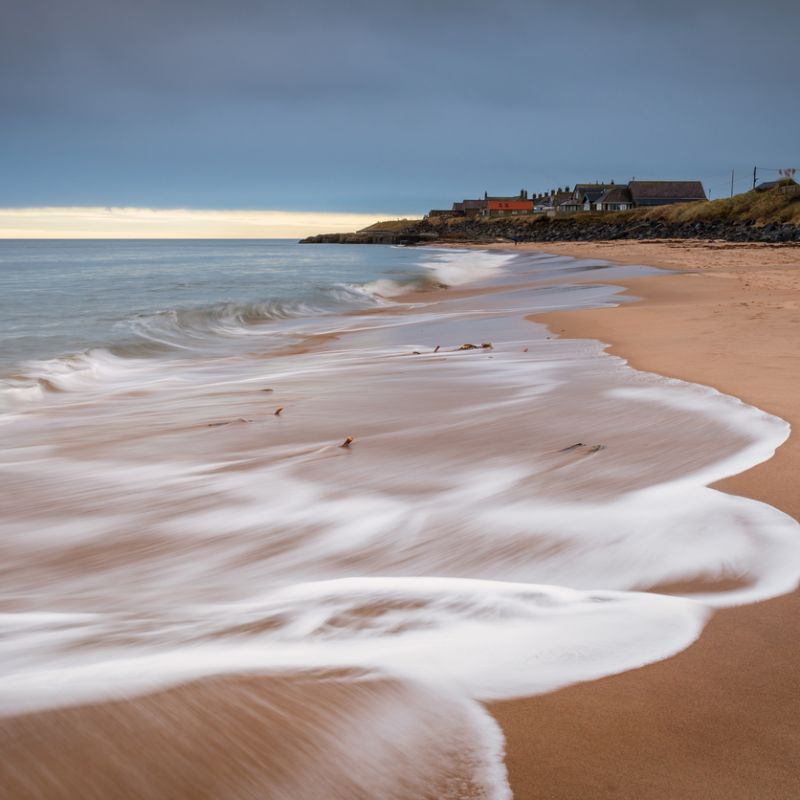 photo of Cresswell Village from the beach at Druridge Bay