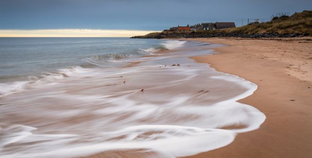 photo of Cresswell Village from the beach at Druridge Bay