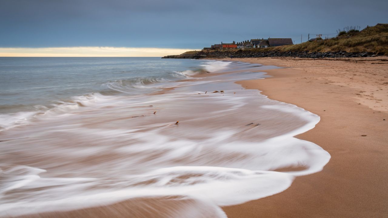 photo of Cresswell Village from the beach at Druridge Bay