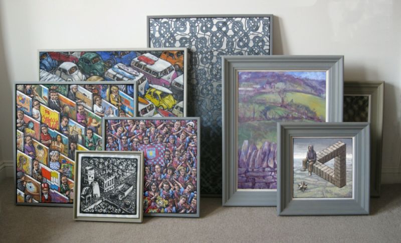 Paintings leaning against a wall