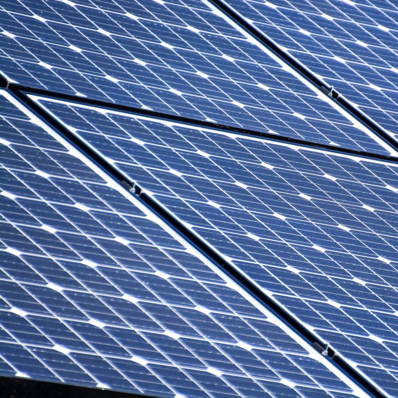 A close up photo showing the top of solar power panels - 3 in a row, 2 rows