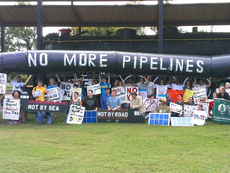 People holding up a fake pipeline to protest against the Keystone XL pipeline in Nashville, United States.