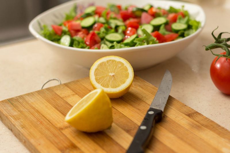 Lemon with salad and chopping board