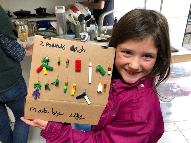 Girl selling Lego earrings