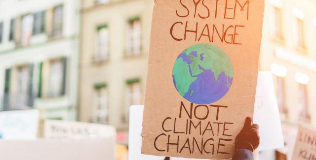 System change not climate change placard