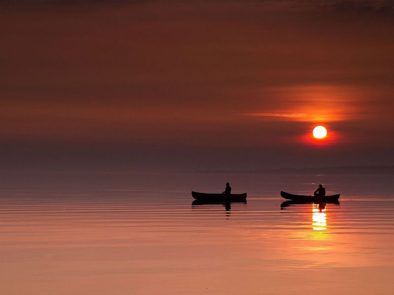 Two canoes on Lough Neagh at sunset