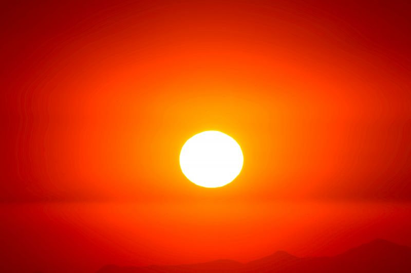 Very bright sun in a very bright fire-like background