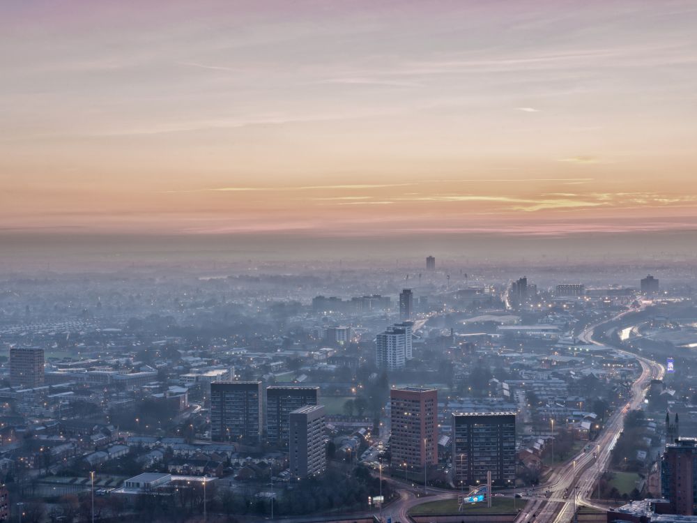 photo of Manchester from the air with haze over the city