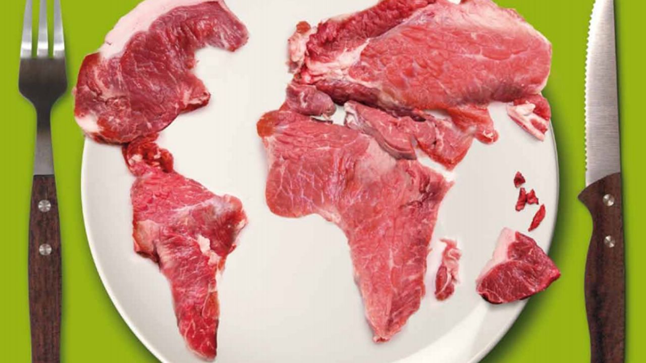 Front cover of the Meat Atlas, showing a globe created from meat on a plate, alongside a knife and fork