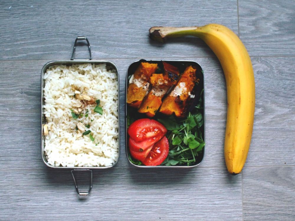 photo of metal lunch box with rice, veg and banana