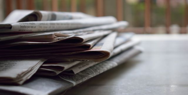 Stack of newspapers on a wooden table
