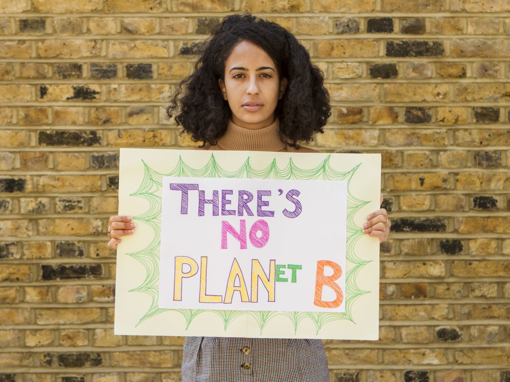 Mia holding there's no planet B sign