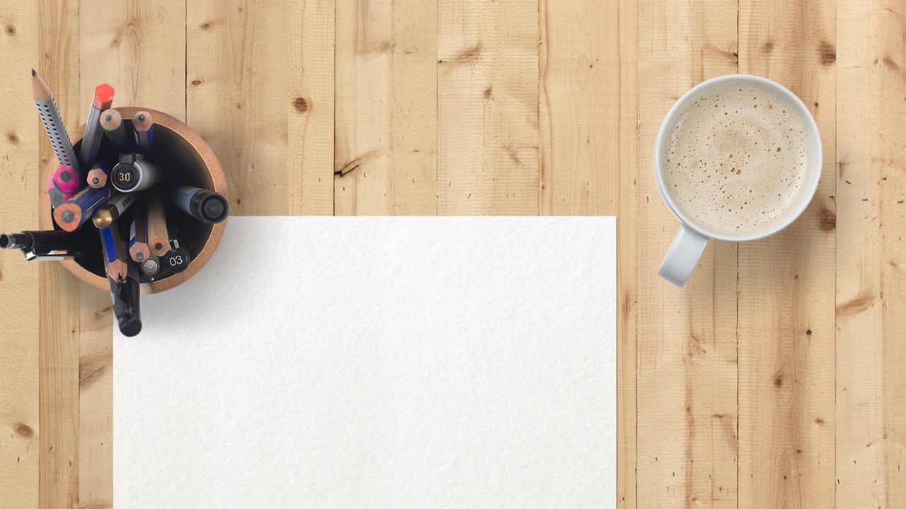 Pencils, paper and coffee cup on desk