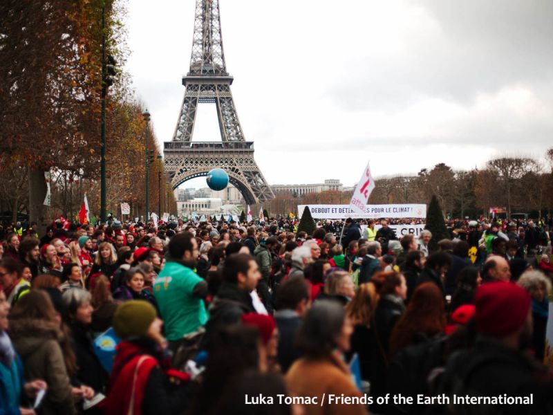 A crowd of people demonstrating at the UN climate talks in Paris, France, December 2015.