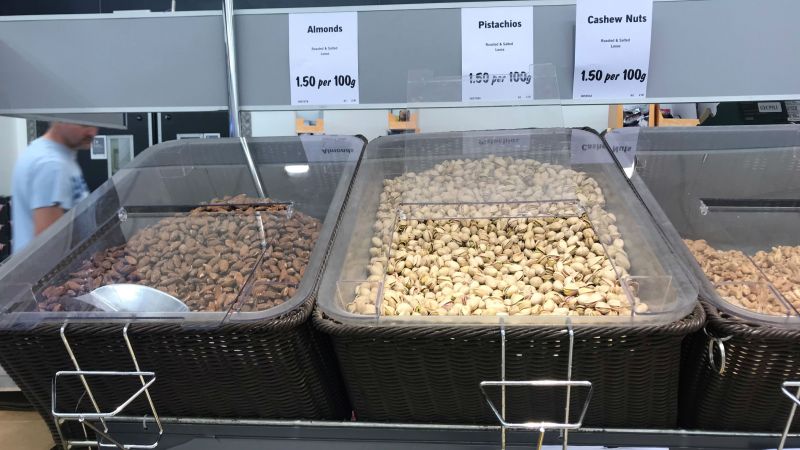 Three trays of self-service 'plastic-free' nuts in supermarket