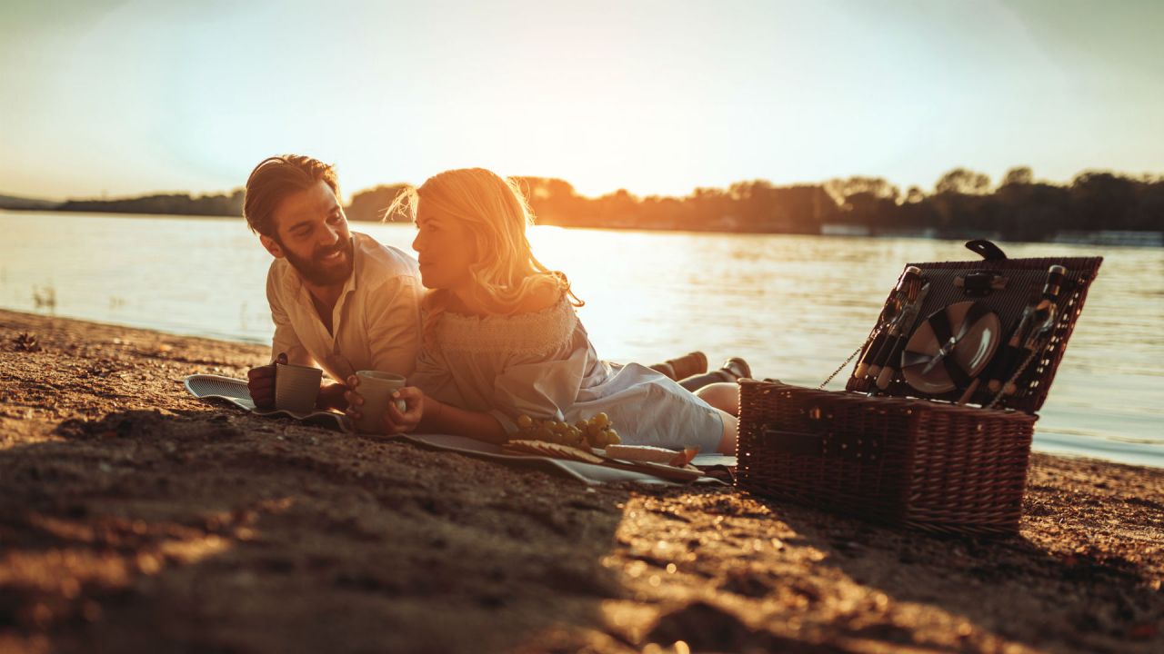 A couple enjoying a picnic on the beach