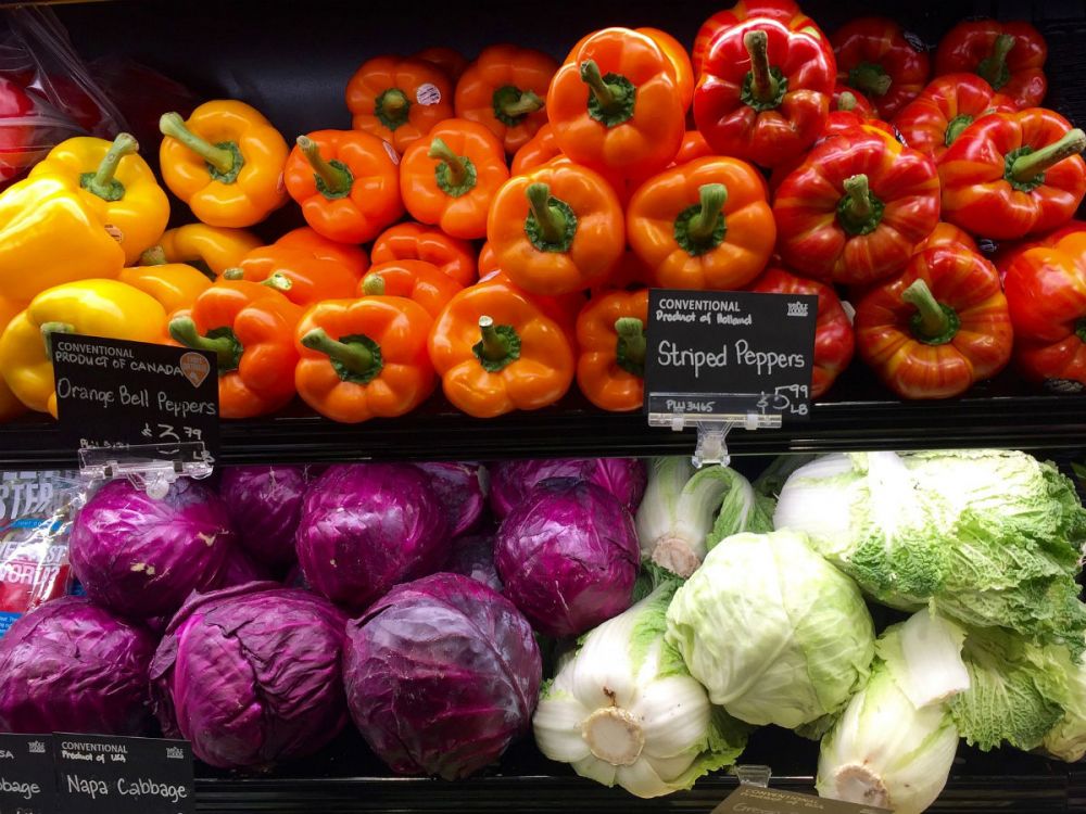 Organic bell peppers in yellow, orange and red.
