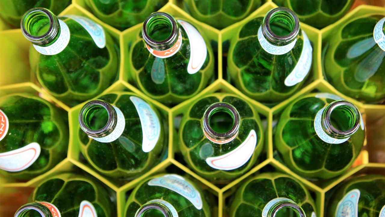 Empty glass bottles in a crate, waiting to be returned for reuse/recycling
