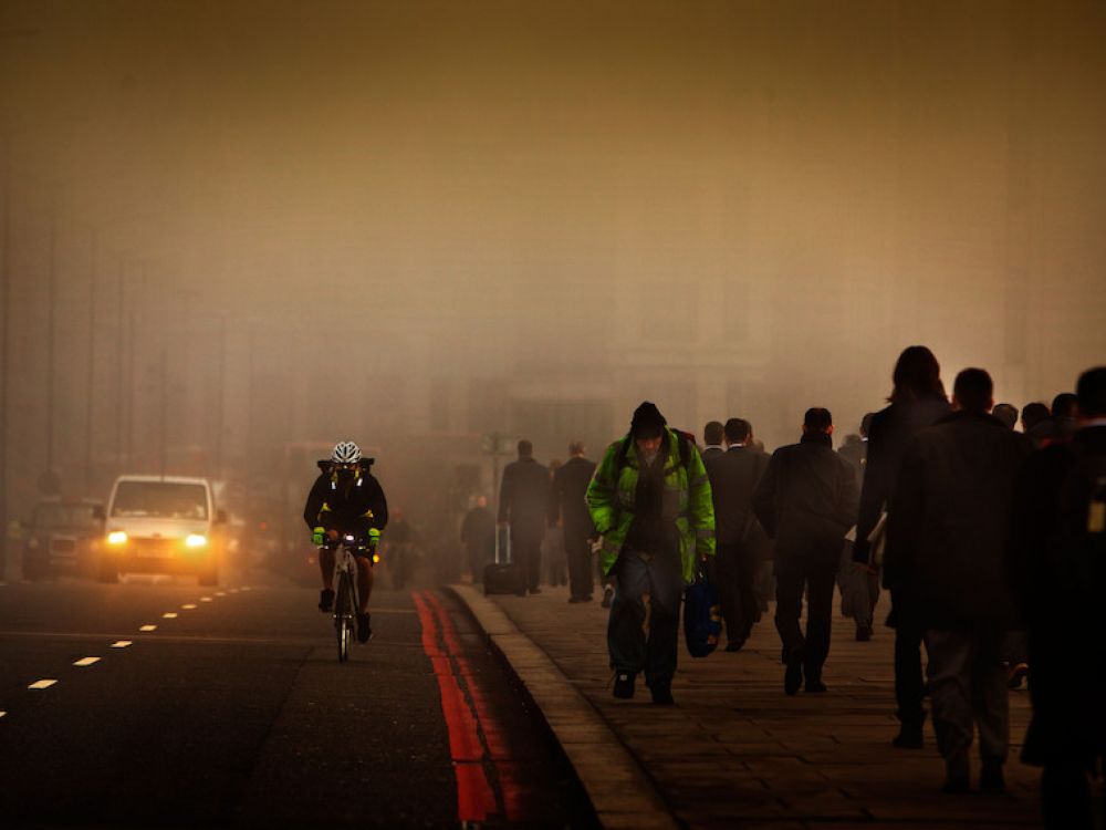 photo of cars, pedestrian and cyclists at night