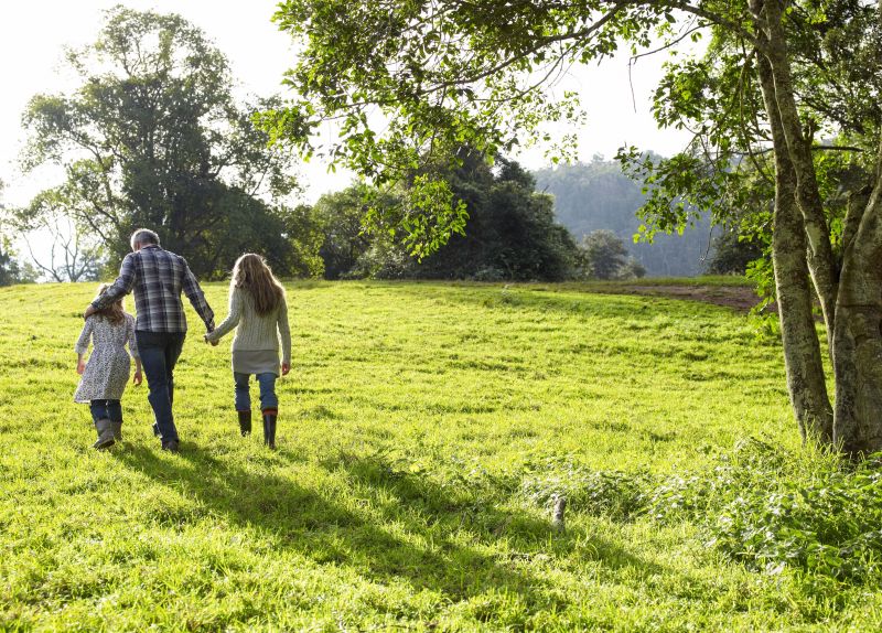 Parent with children walking across field