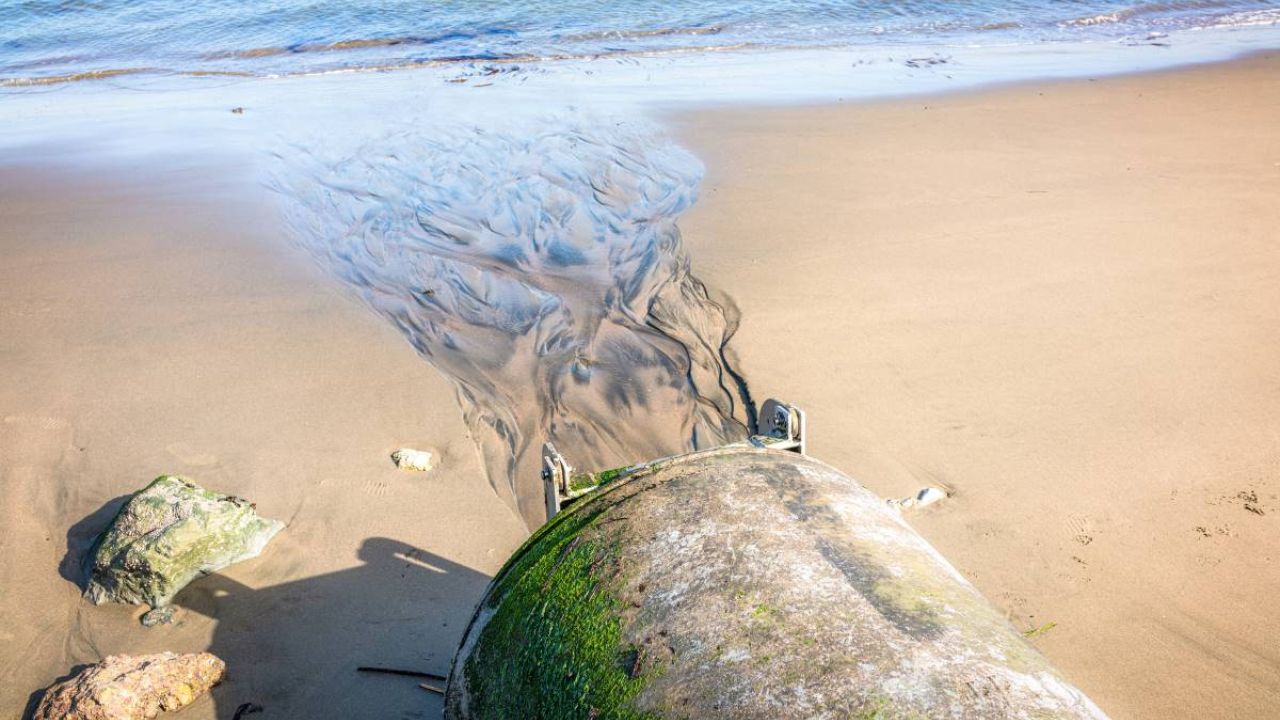 Sewage flowing from a pipe into the sea