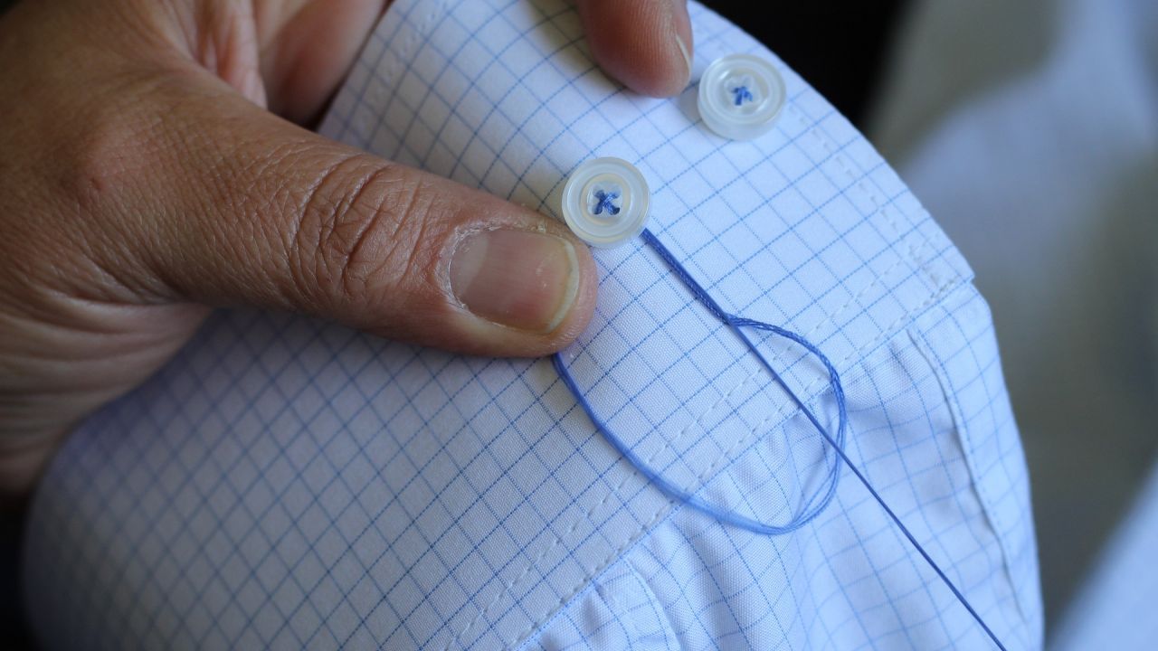 Sewing button back on to a shirt