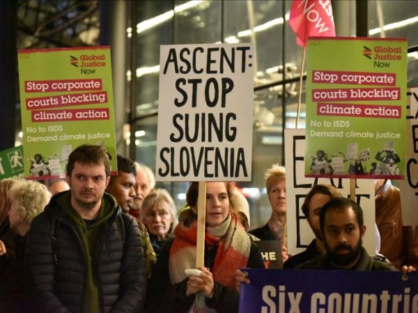 Group of protesters holding placards in solidarity with Slovenia and against the Energy Charter Treaty