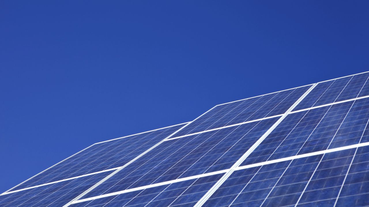 Solar panels and a blue sky backdrop