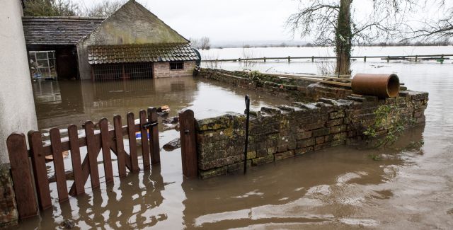 A house and its grounds inundated with flood water in Somerset.