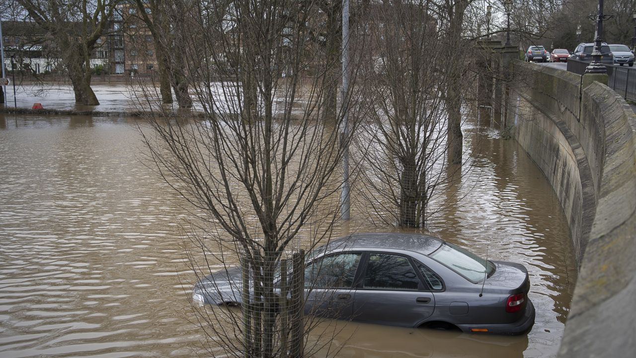 A car park with car submerged after flooding in York, 2020.
