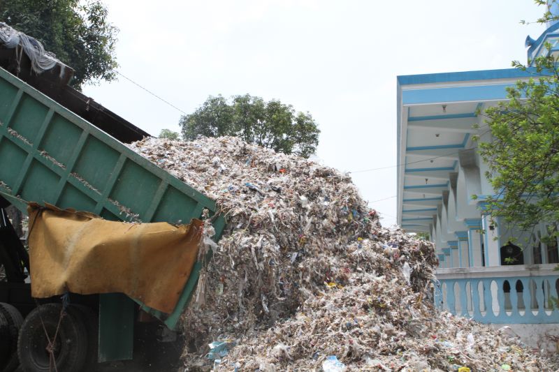 A household requests plastic waste to be dumped outside their home