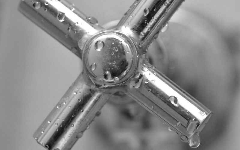 Close-up of wet tap handle in bathroom