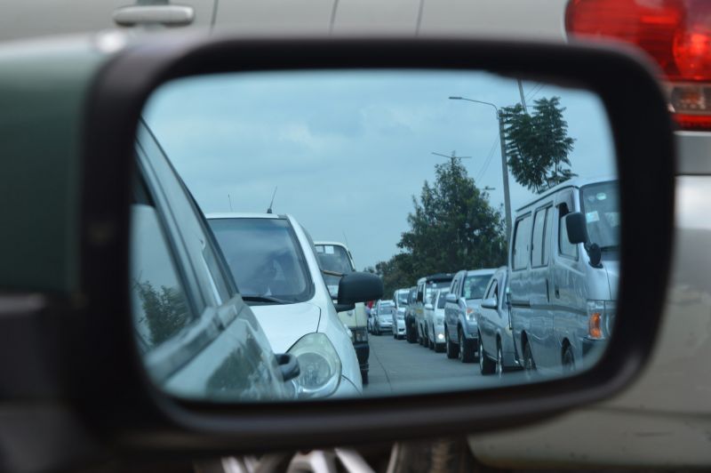 Long traffic jam viewed in car wing mirror