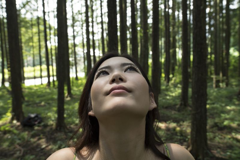 Tree facts: a woman breathing in the fresh air of the forest