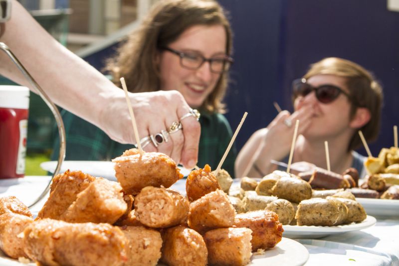 Friends of the Earth staff trying veggie sausages