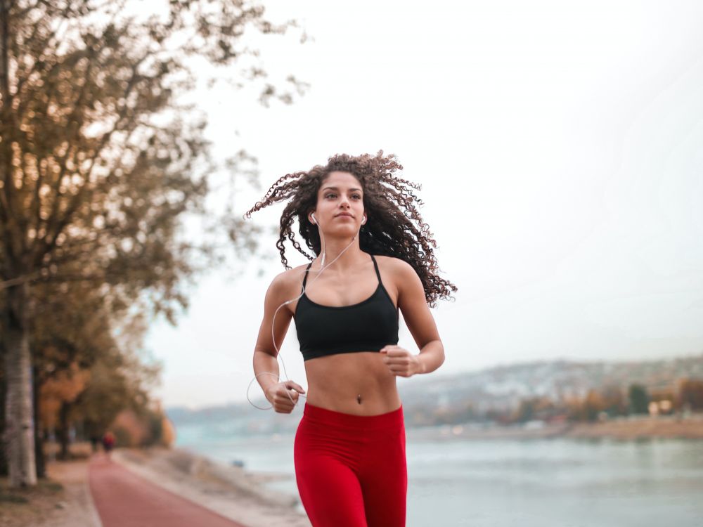 Woman running by river