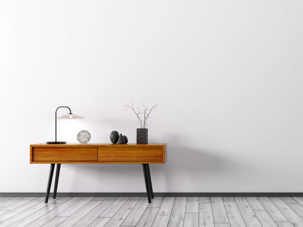 A photo of a wooden cabinet on wooden floorboards in a living room