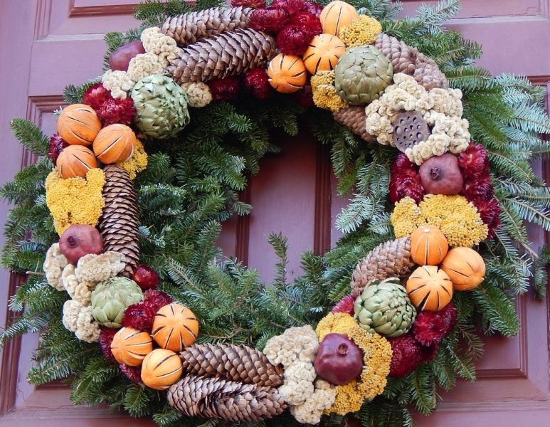 Christmas wreath with dried flowers, fruits etc on door