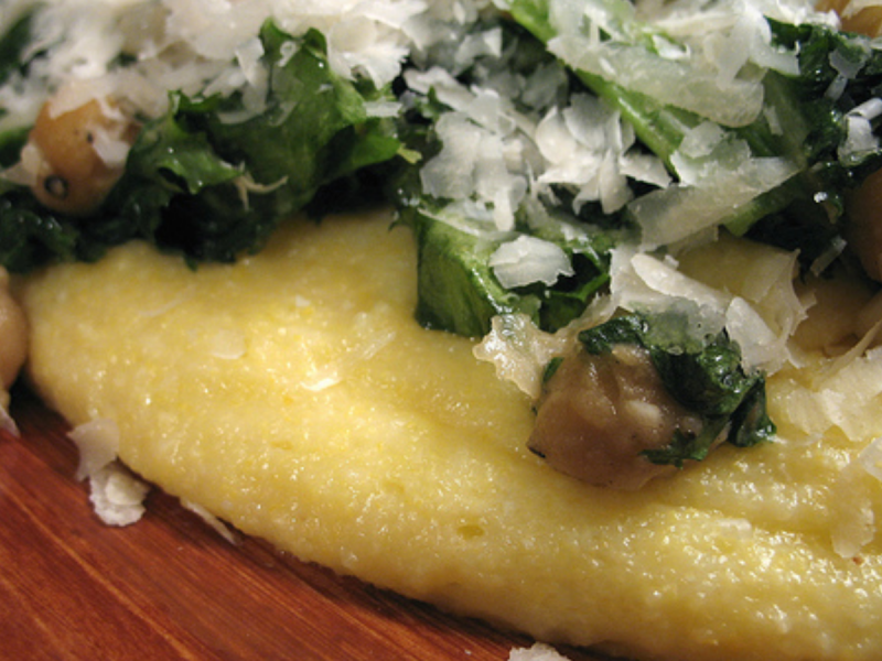 Vegetarian dish of chickpeas and greens on a bed of polenta