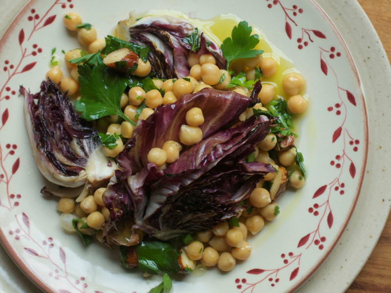 Vegan chickpea salad with warmed leaves on a plate