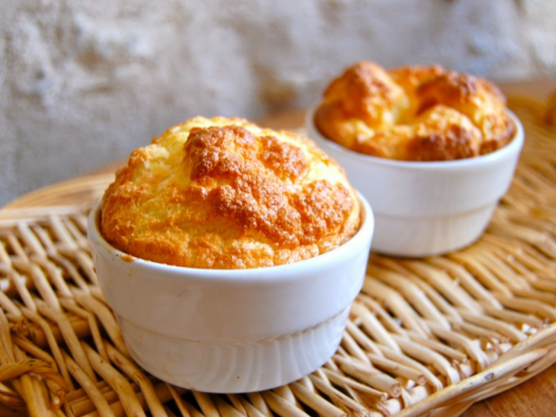 Cheap cheese pudding in two ramekins on a wicker basket